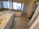 Bathroom with double sinks, tile flooring, and a separate shower and bathtub at 7604 Cruz Bay Ct, Las Vegas, NV 89128