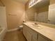 Cozy bathroom with a single sink vanity, large mirror, and a shower and tub at 7604 Cruz Bay Ct, Las Vegas, NV 89128