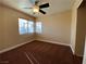 Bright bedroom features a ceiling fan and large windows with views at 7604 Cruz Bay Ct, Las Vegas, NV 89128