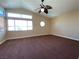 Large bedroom featuring vaulted ceiling, generous windows, and neutral walls at 7604 Cruz Bay Ct, Las Vegas, NV 89128