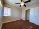 Neutral bedroom with a ceiling fan, window, and closet at 7604 Cruz Bay Ct, Las Vegas, NV 89128