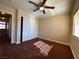 Neutral bedroom with a ceiling fan, large closet, and natural light through the window at 7604 Cruz Bay Ct, Las Vegas, NV 89128