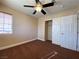 Cozy bedroom with a ceiling fan, closet, and a large window for natural light at 7604 Cruz Bay Ct, Las Vegas, NV 89128
