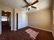 Neutral bedroom with a ceiling fan, large closet, and warm brown carpet at 7604 Cruz Bay Ct, Las Vegas, NV 89128