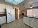 Open kitchen featuring white appliances and a view of the living area with a fireplace at 7604 Cruz Bay Ct, Las Vegas, NV 89128