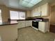 Bright kitchen with white cabinets, granite countertops, and tile floors at 7604 Cruz Bay Ct, Las Vegas, NV 89128
