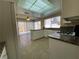 Bright eat-in kitchen with tile flooring, granite counters, and sliding glass doors to the backyard at 7604 Cruz Bay Ct, Las Vegas, NV 89128
