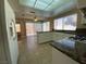 Bright kitchen featuring tile flooring, white cabinetry, granite countertops and stainless appliances at 7604 Cruz Bay Ct, Las Vegas, NV 89128