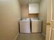 Practical laundry area featuring a washer, dryer, and overhead cabinet at 7604 Cruz Bay Ct, Las Vegas, NV 89128
