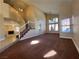 Bright open living space with two-story ceilings, neutral colors, carpet, and a fireplace at 7604 Cruz Bay Ct, Las Vegas, NV 89128