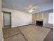 Inviting living room with fireplace, tile floors, and ample natural light from the window at 7604 Cruz Bay Ct, Las Vegas, NV 89128