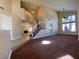 Spacious living room features high ceilings, carpet, and staircase leading to the upper level at 7604 Cruz Bay Ct, Las Vegas, NV 89128