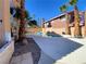 Inviting outdoor pool area surrounded by lush palm trees and a well-maintained deck at 7604 Cruz Bay Ct, Las Vegas, NV 89128