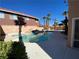 Beautiful backyard pool with spa, rock features, and mature palm trees at 7604 Cruz Bay Ct, Las Vegas, NV 89128