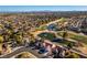 Stunning aerial view of a residential area featuring beautiful landscaping, golf course, and pond at 8713 Litchfield Ave, Las Vegas, NV 89134