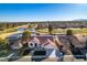Aerial view showcases a well-maintained home adjacent to a scenic golf course with lush landscaping and water features at 8713 Litchfield Ave, Las Vegas, NV 89134