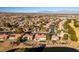 Expansive aerial view of a well-maintained suburban neighborhood, a lake and the mountains in the distance at 8713 Litchfield Ave, Las Vegas, NV 89134