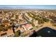 Breathtaking aerial view capturing a community near a peaceful lake, highlighting manicured lawns and landscaping at 8713 Litchfield Ave, Las Vegas, NV 89134