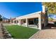 Spacious backyard featuring a lush lawn, patio, and views of the surrounding landscape at 8713 Litchfield Ave, Las Vegas, NV 89134