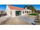 Exterior view of the home with a lush lawn, patio, and well-maintained landscaping at 8713 Litchfield Ave, Las Vegas, NV 89134