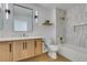 Modern bathroom features dual vanities, shower over tub, and wood flooring at 8713 Litchfield Ave, Las Vegas, NV 89134