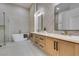Elegant bathroom featuring double vanities, a freestanding tub, and a glass-enclosed shower at 8713 Litchfield Ave, Las Vegas, NV 89134