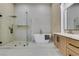 Sleek bathroom with a glass-enclosed shower, freestanding tub, and modern vanity with double sinks at 8713 Litchfield Ave, Las Vegas, NV 89134