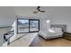 Bright bedroom with large windows, a ceiling fan, and a modern fireplace feature at 8713 Litchfield Ave, Las Vegas, NV 89134