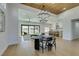 Open concept living area with wood ceiling, modern lighting, dining table, and a view into the stylish kitchen at 8713 Litchfield Ave, Las Vegas, NV 89134
