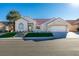 Charming single-story home with a well-manicured lawn, elegant front entrance, and a spacious driveway leading to the garage at 8713 Litchfield Ave, Las Vegas, NV 89134