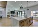 Spacious kitchen with a center island, stainless steel appliances, and access to outdoor living space at 8713 Litchfield Ave, Las Vegas, NV 89134