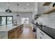 Contemporary kitchen showcasing white and wood cabinets, a marble island, and a view of the outdoors at 8713 Litchfield Ave, Las Vegas, NV 89134