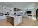 Open-concept kitchen with a large island, stainless steel appliances, and seamless flow to the living area at 8713 Litchfield Ave, Las Vegas, NV 89134