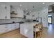 Bright kitchen boasts white cabinets, stainless steel appliances, and a large island with bar seating at 8713 Litchfield Ave, Las Vegas, NV 89134