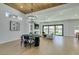 Open concept living area featuring modern lighting, wood ceiling, contemporary furniture, and glass sliding doors at 8713 Litchfield Ave, Las Vegas, NV 89134