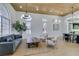 Bright and airy living room featuring a wooden ceiling, modern lighting, stylish furniture, and large windows at 8713 Litchfield Ave, Las Vegas, NV 89134