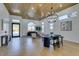 Spacious, open living area featuring modern lighting, wood ceiling, contemporary furniture, and a dining space at 8713 Litchfield Ave, Las Vegas, NV 89134