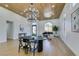 Spacious, open living area featuring modern lighting, wood ceiling, contemporary furniture, and large arched window at 8713 Litchfield Ave, Las Vegas, NV 89134