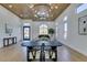 Expansive open living area showcasing modern lighting, wood ceiling, contemporary furniture, and large arched windows at 8713 Litchfield Ave, Las Vegas, NV 89134