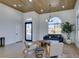 Inviting living room with a modern sofa, stylish chairs, a decorative tree, and a large window for natural light at 8713 Litchfield Ave, Las Vegas, NV 89134