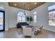 Bright, open living room featuring a wood ceiling, modern lighting, large windows, and stylish contemporary furniture at 8713 Litchfield Ave, Las Vegas, NV 89134