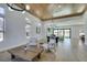 Spacious living room with hardwood floors, modern furniture, a stylish ceiling, and seamless access to the outdoor area at 8713 Litchfield Ave, Las Vegas, NV 89134