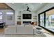 Open-concept living room leads to an outdoor patio and features a modern fireplace at 8713 Litchfield Ave, Las Vegas, NV 89134