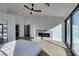 Bright main bedroom with modern fireplace, ceiling fan, and outdoor views at 8713 Litchfield Ave, Las Vegas, NV 89134
