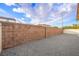Backyard enclosed by a tall block wall, with a gravel groundcover at 9146 Grand Sunburst Ct, Las Vegas, NV 89149