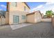 Spacious backyard with a gravel area, small patio and rear entrance to home at 9146 Grand Sunburst Ct, Las Vegas, NV 89149