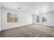 Bright bedroom with neutral carpet, crown molding, and large windows allowing lots of natural light at 9146 Grand Sunburst Ct, Las Vegas, NV 89149