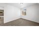 Bedroom featuring neutral carpet, base trim, and a window providing natural light at 9146 Grand Sunburst Ct, Las Vegas, NV 89149