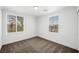 Bright bedroom featuring neutral carpet, base trim and natural light from two windows at 9146 Grand Sunburst Ct, Las Vegas, NV 89149
