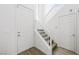 Hallway leading to the upper level of the home with carpeted stairs and a white railing at 9146 Grand Sunburst Ct, Las Vegas, NV 89149